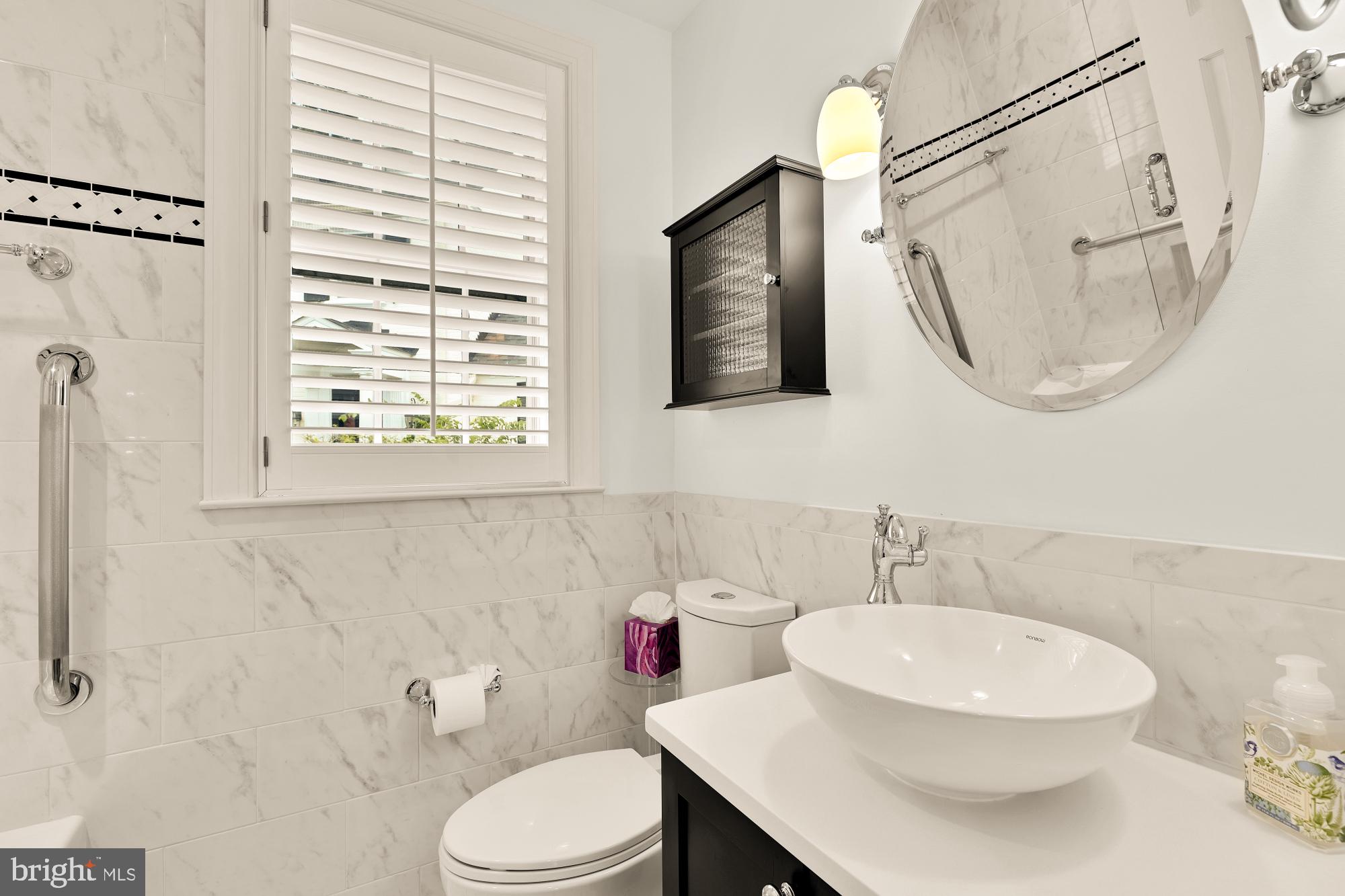 6038 Fort Hunt Road Alexandria, VA 22307 - Photo 32 of 49 a bathroom with a sink a toilet and a mirror