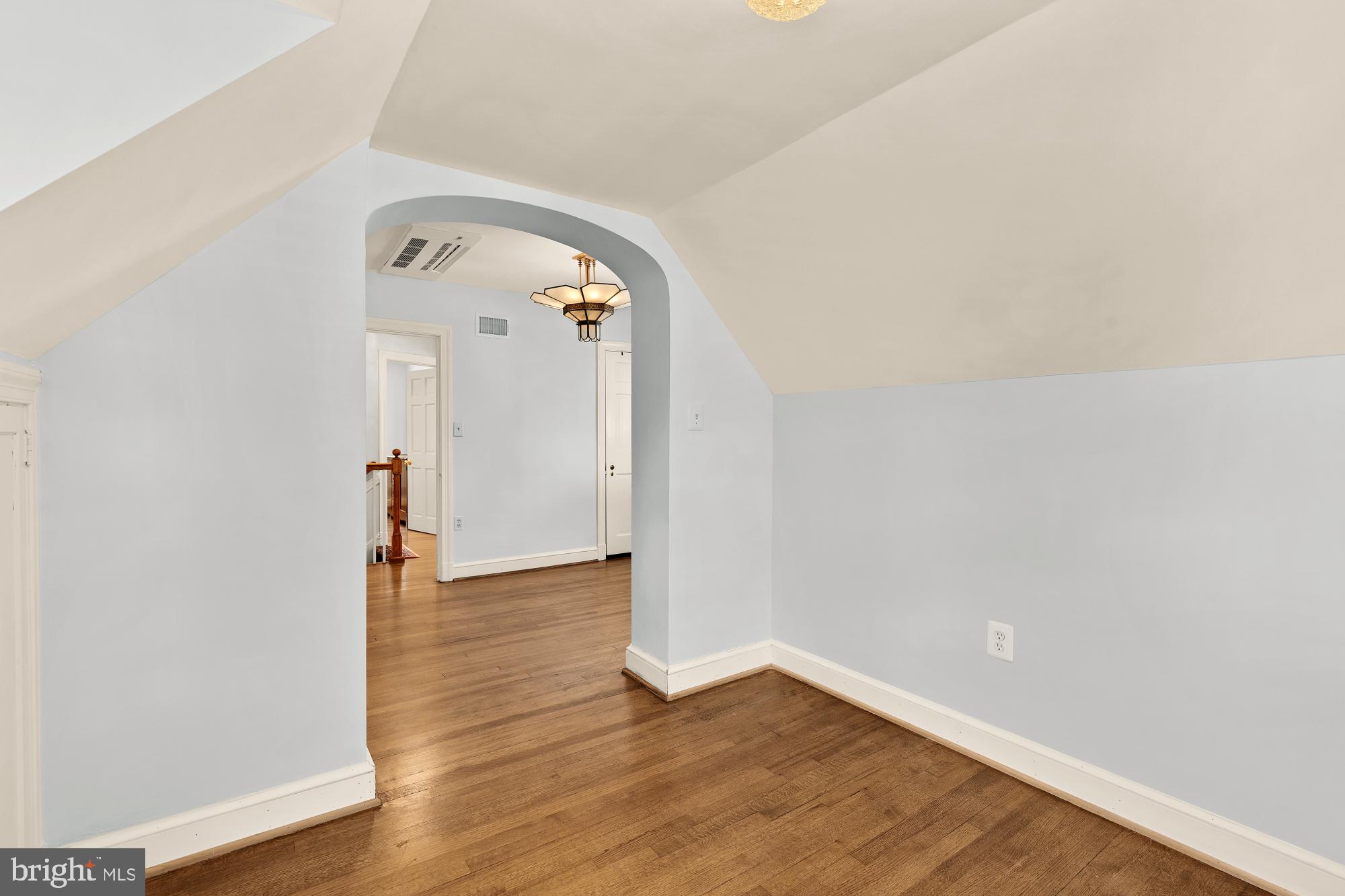 6038 Fort Hunt Road Alexandria, VA 22307 - Photo 38 of 49 an empty room with wooden floor and mirror