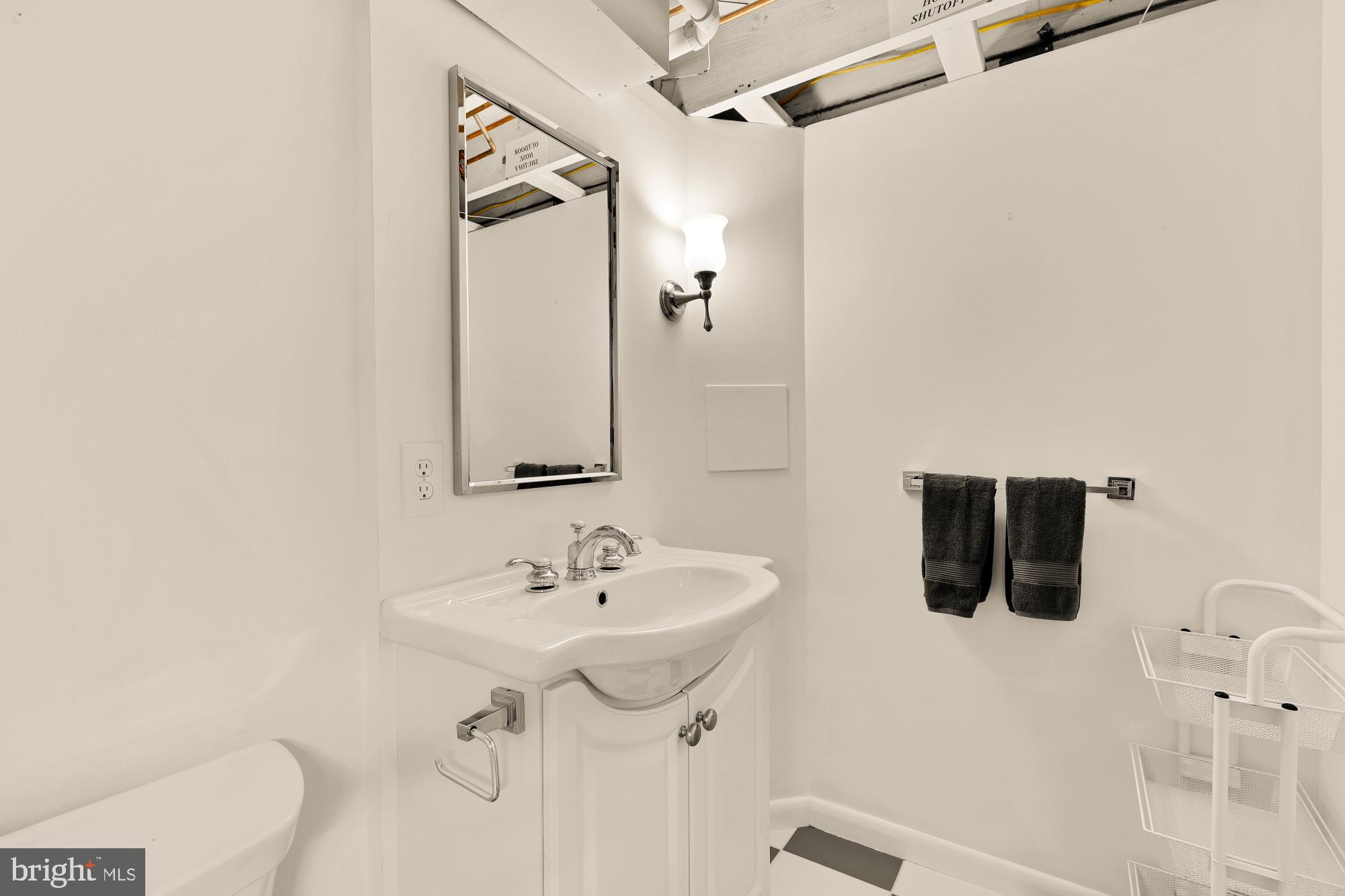 6038 Fort Hunt Road Alexandria, VA 22307 - Photo 40 of 49 a bathroom with a sink a toilet and shower