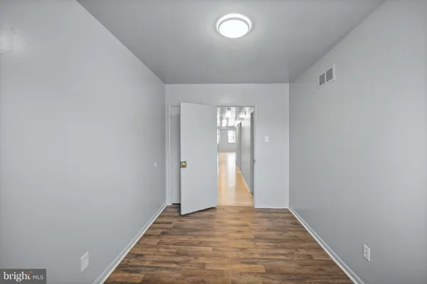 a view of an empty room and wooden floor