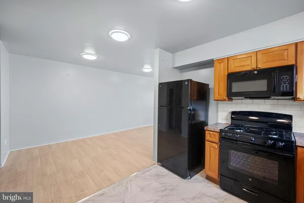 a kitchen with stainless steel appliances a refrigerator and a stove top oven