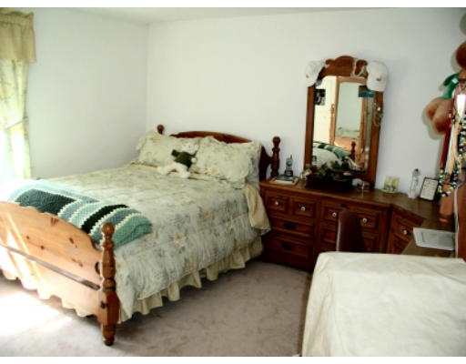 37 Clover Road Holbrook, MA 02343 - Photo 6 of 8 a bedroom with a bed and a mirror on dresser