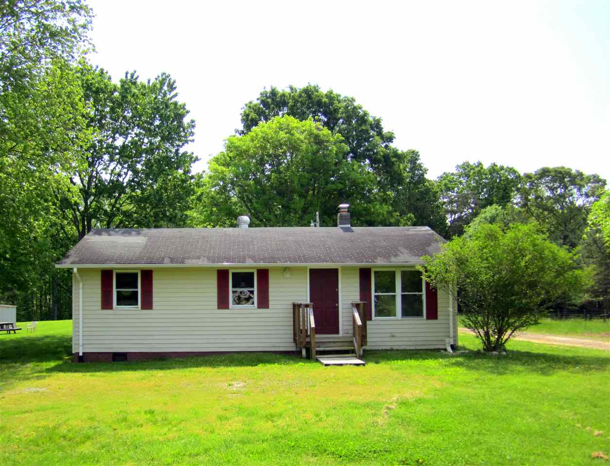 5576 Buckner Road Bumpass, VA 23024 - Photo 1 of 12 a front view of a house with a garden
