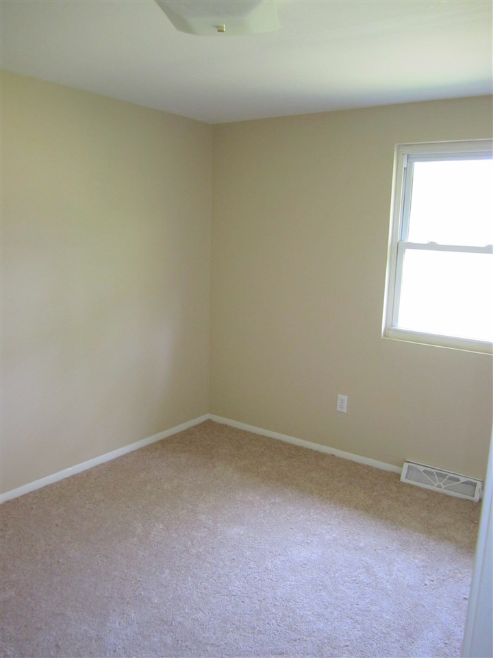 5576 Buckner Road Bumpass, VA 23024 - Photo 6 of 12 an empty room with a window