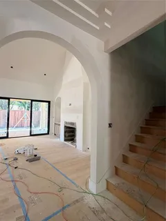 a view of an empty room with a fireplace and a window
