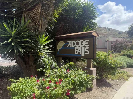 a sign broad in front of flowers