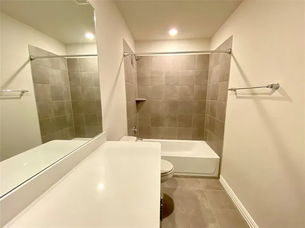 an empty room with closet and a window