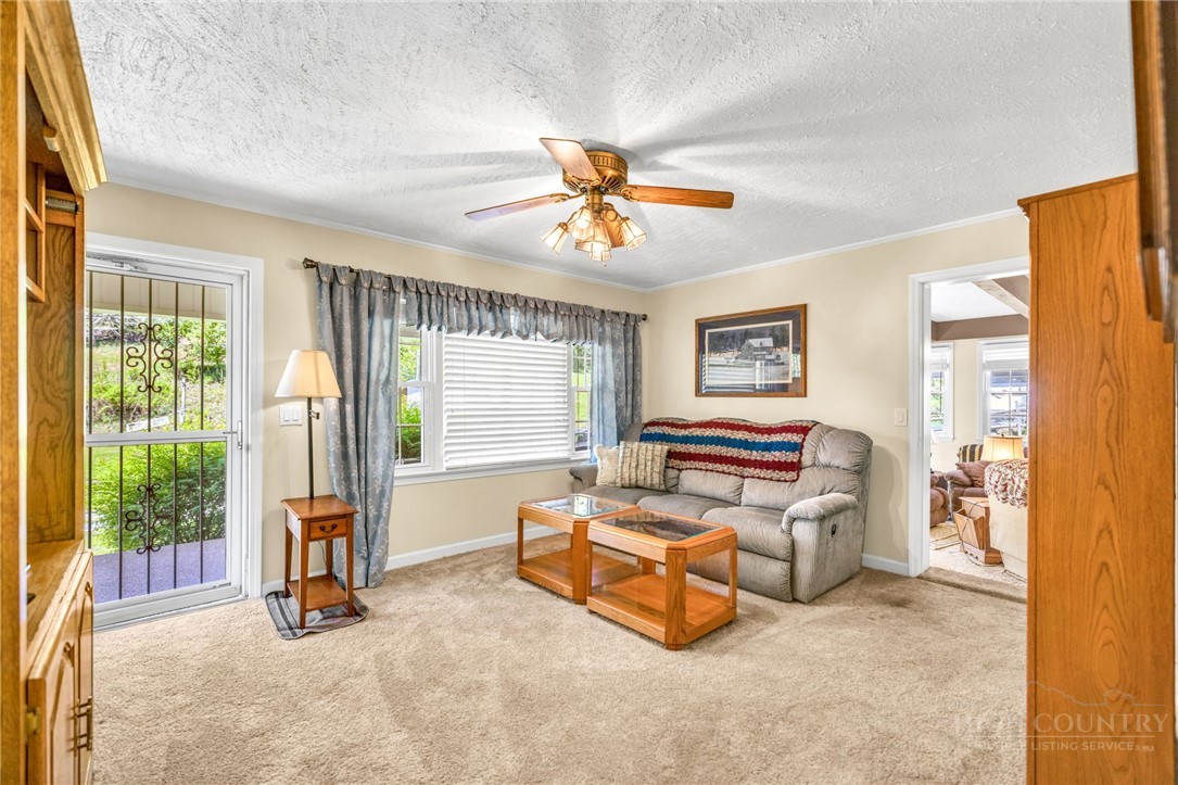 346 Piney Creek Road Lansing, NC 28643 - Photo 16 of 24 a living room with furniture and a chandelier
