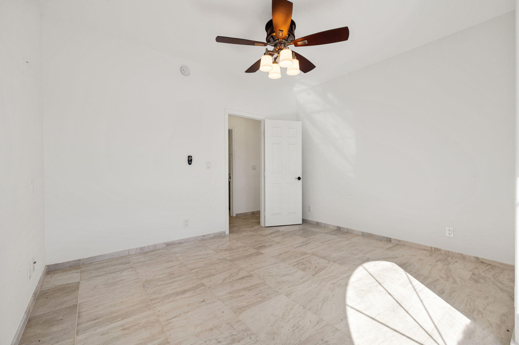 62734 Starlight Street Joshua Tree, CA 92252 - Photo 33 of 60 an empty room with a chandelier fan and windows