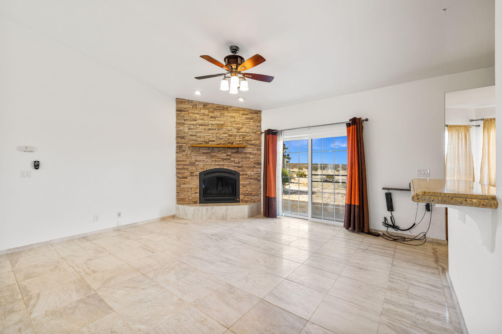 62734 Starlight Street Joshua Tree, CA 92252 - Photo 7 of 60 a view of a livingroom with a fireplace a sink and dishwasher next to a window