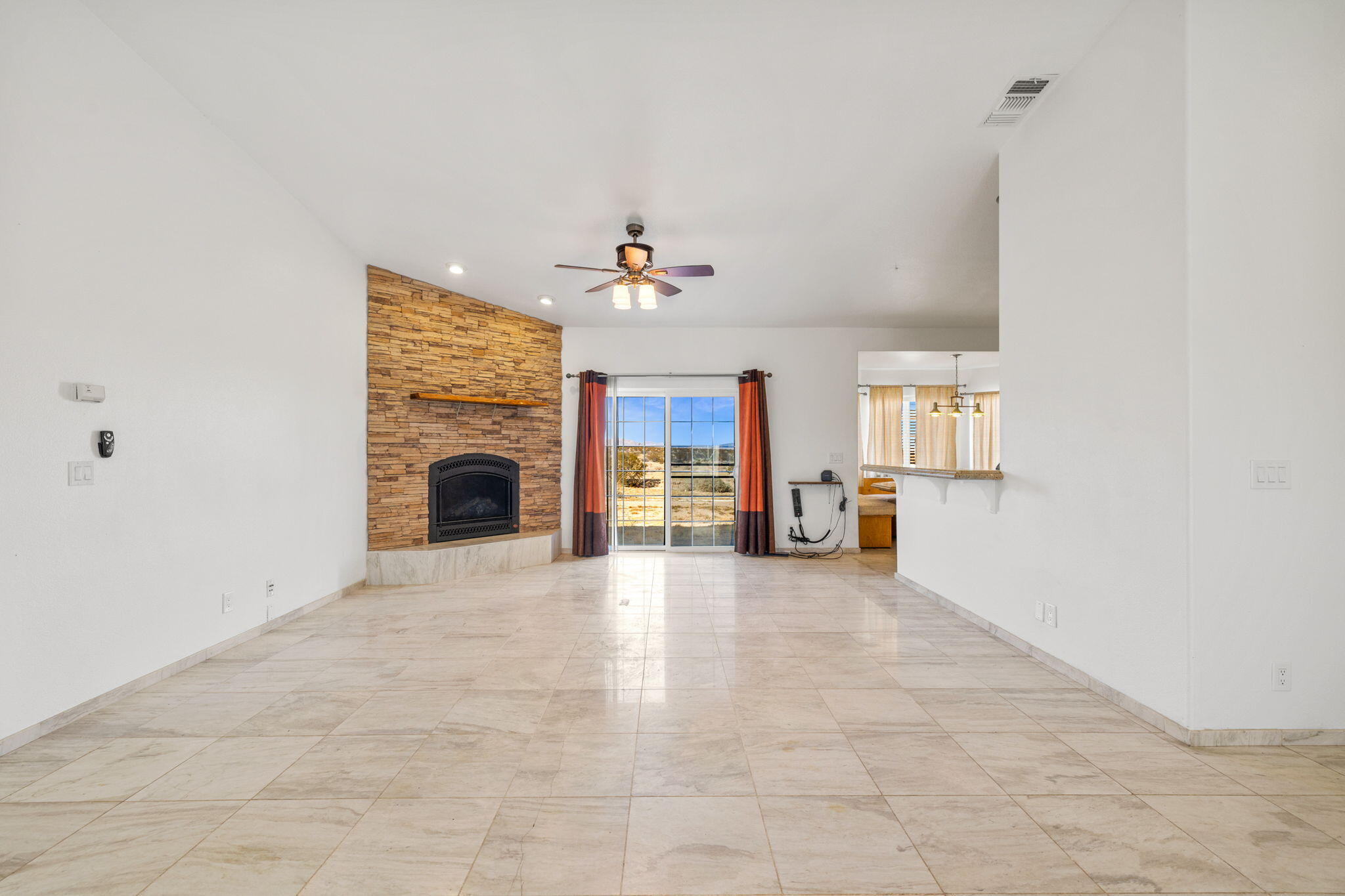62734 Starlight Street Joshua Tree, CA 92252 - Photo 9 of 60 a view of an empty room with a fireplace