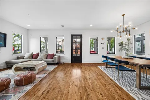 a bedroom with furniture and a wooden floor