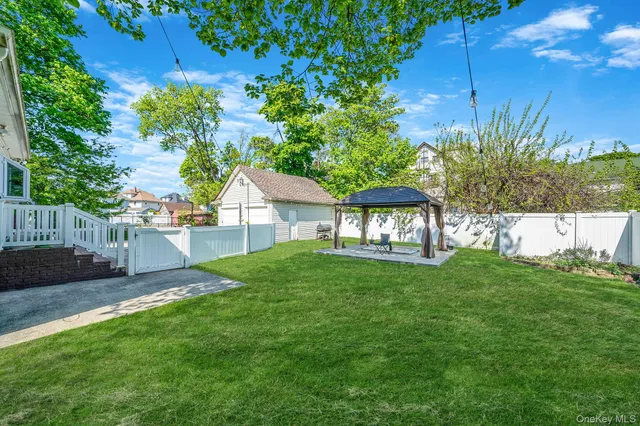 a view of a house with backyard and sitting area