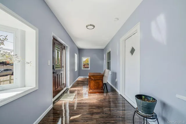 a view of entryway and hall with wooden floor