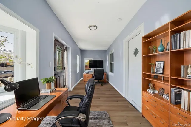 a living room with furniture and a book shelf