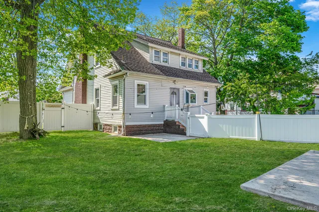 a view of a house with a yard and sitting area