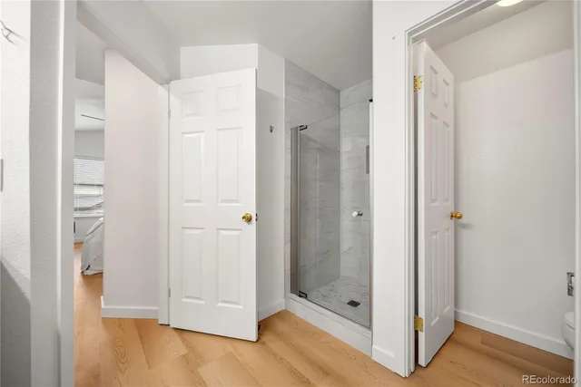 a bathroom with a shower and a glass door