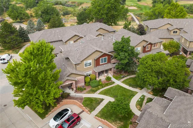 an aerial view of multiple houses with yard
