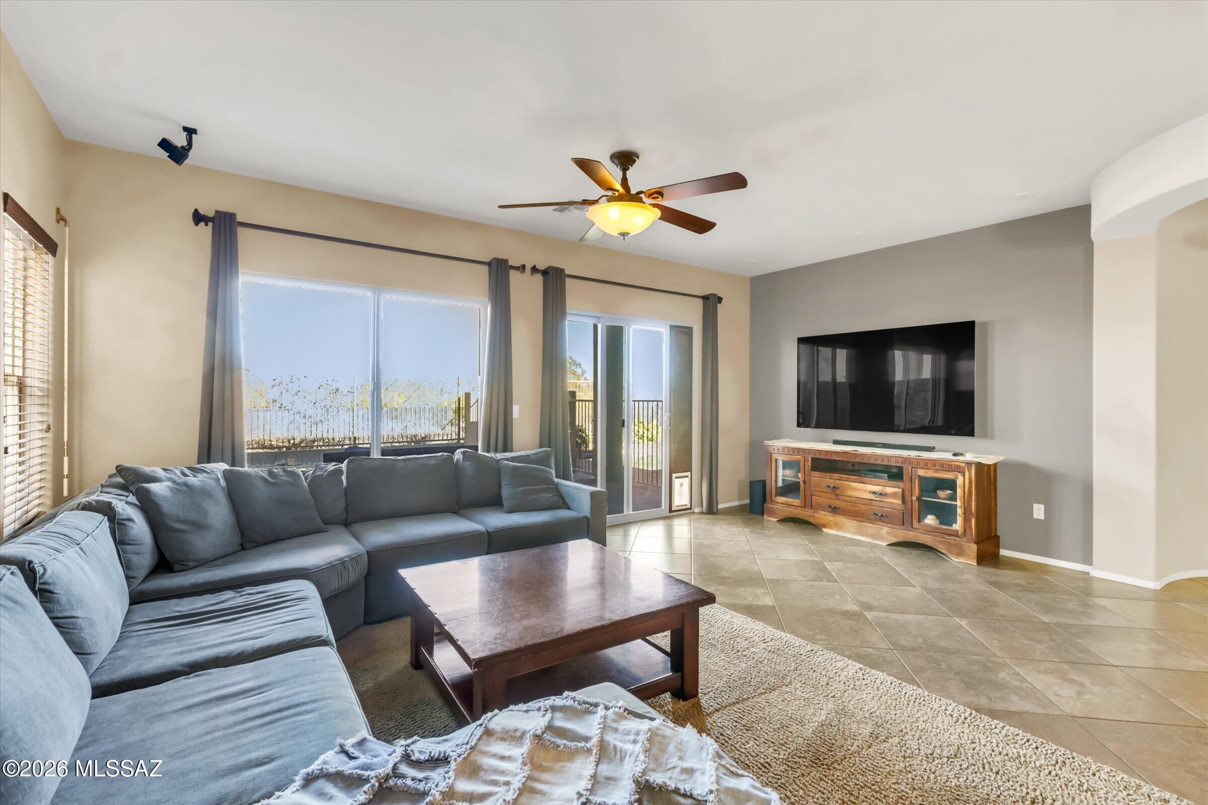 6095 South Jakemp Trail Tucson, AZ 85747 - Photo 17 of 52 a living room with furniture and a flat screen tv