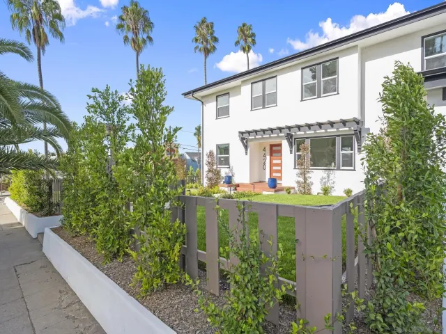 a front view of a house with a garden