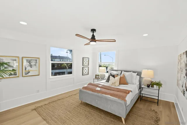 a bathroom with a granite countertop toilet a sink a mirror and shower