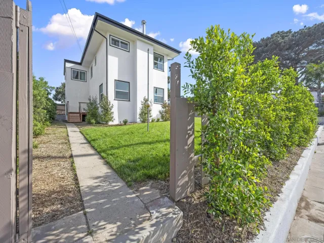 a front view of a house with garden