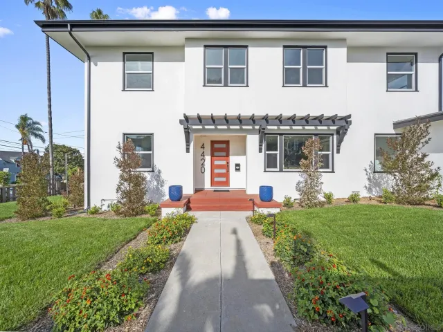 a front view of a house with a yard and porch
