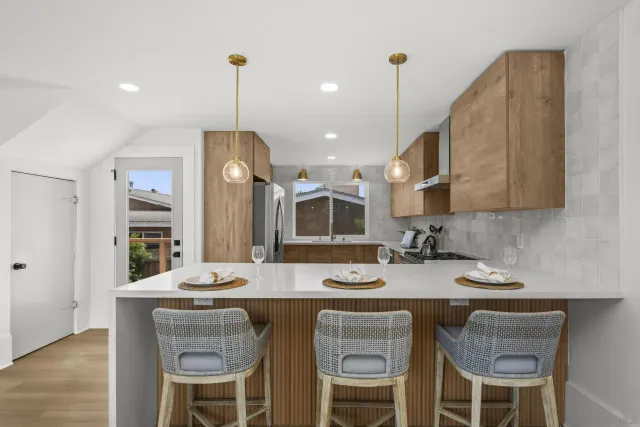 a kitchen with a table chairs stove and microwave