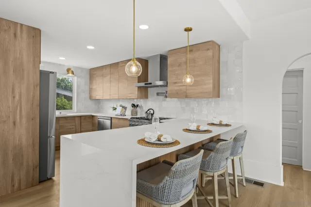 a kitchen with stainless steel appliances a stove a sink and cabinets