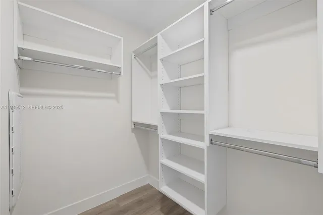 a bedroom with furniture and a large window