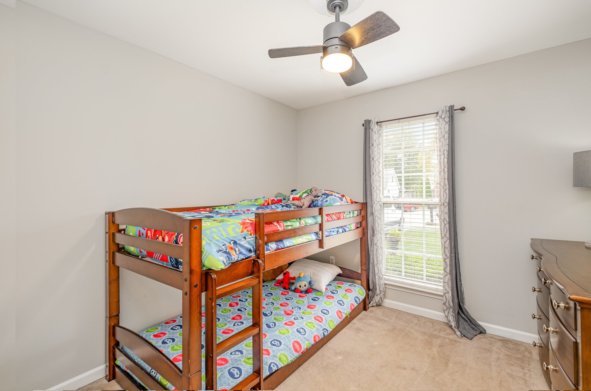 1312 Chapman Court Spring Hill, TN 37174 - Photo 16 of 27 a bedroom with a bed and a chandelier