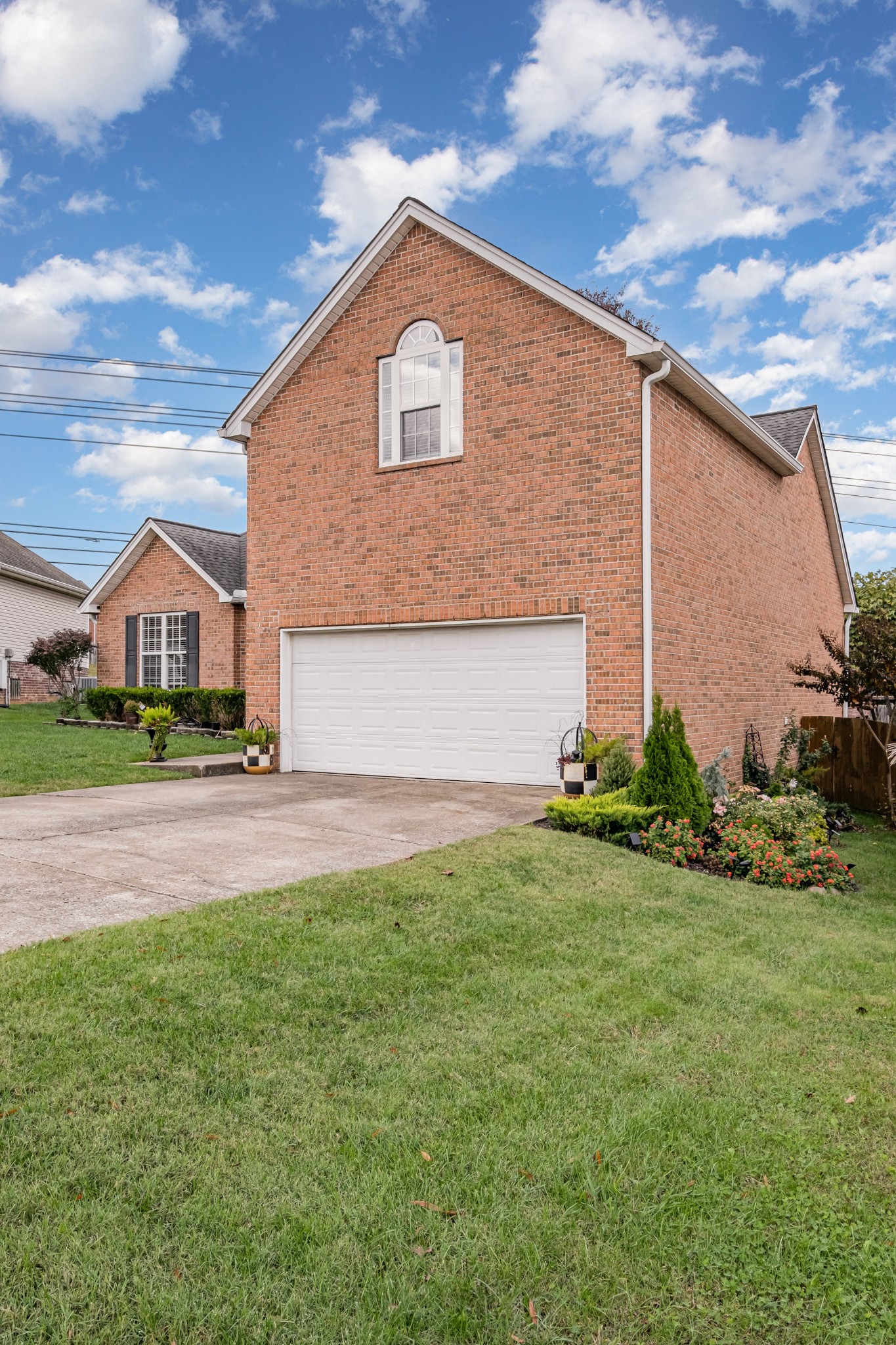 1312 Chapman Court Spring Hill, TN 37174 - Photo 26 of 27 a front view of a house with a yard and garage