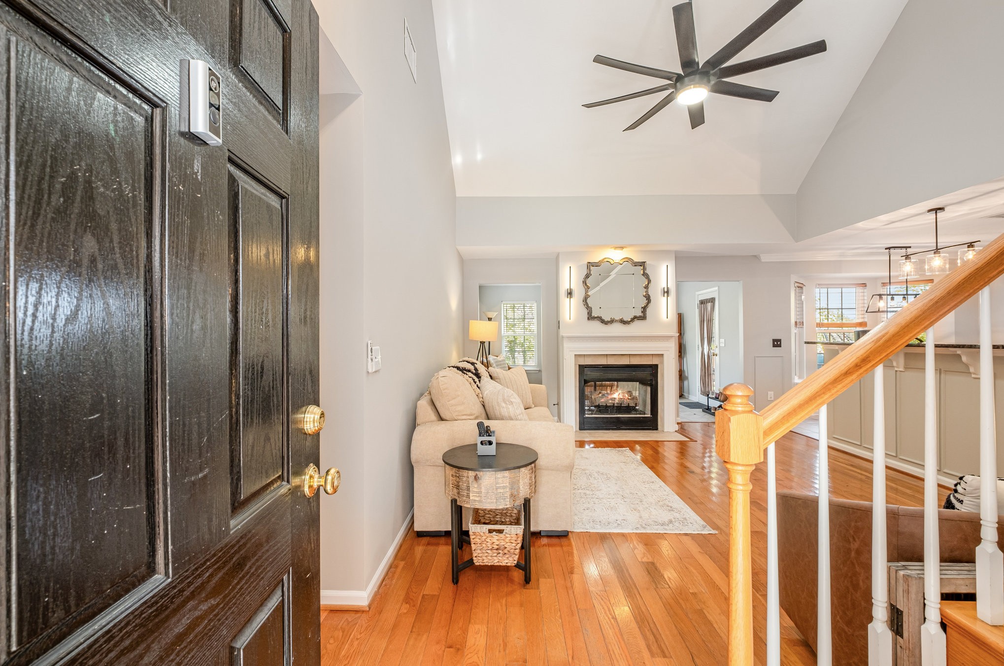1312 Chapman Court Spring Hill, TN 37174 - Photo 3 of 27 a living room with furniture a fireplace and a chandelier