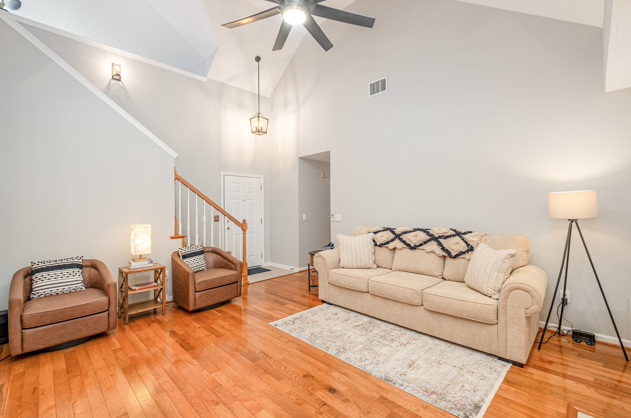 1312 Chapman Court Spring Hill, TN 37174 - Photo 6 of 27 a living room with furniture and a chandelier