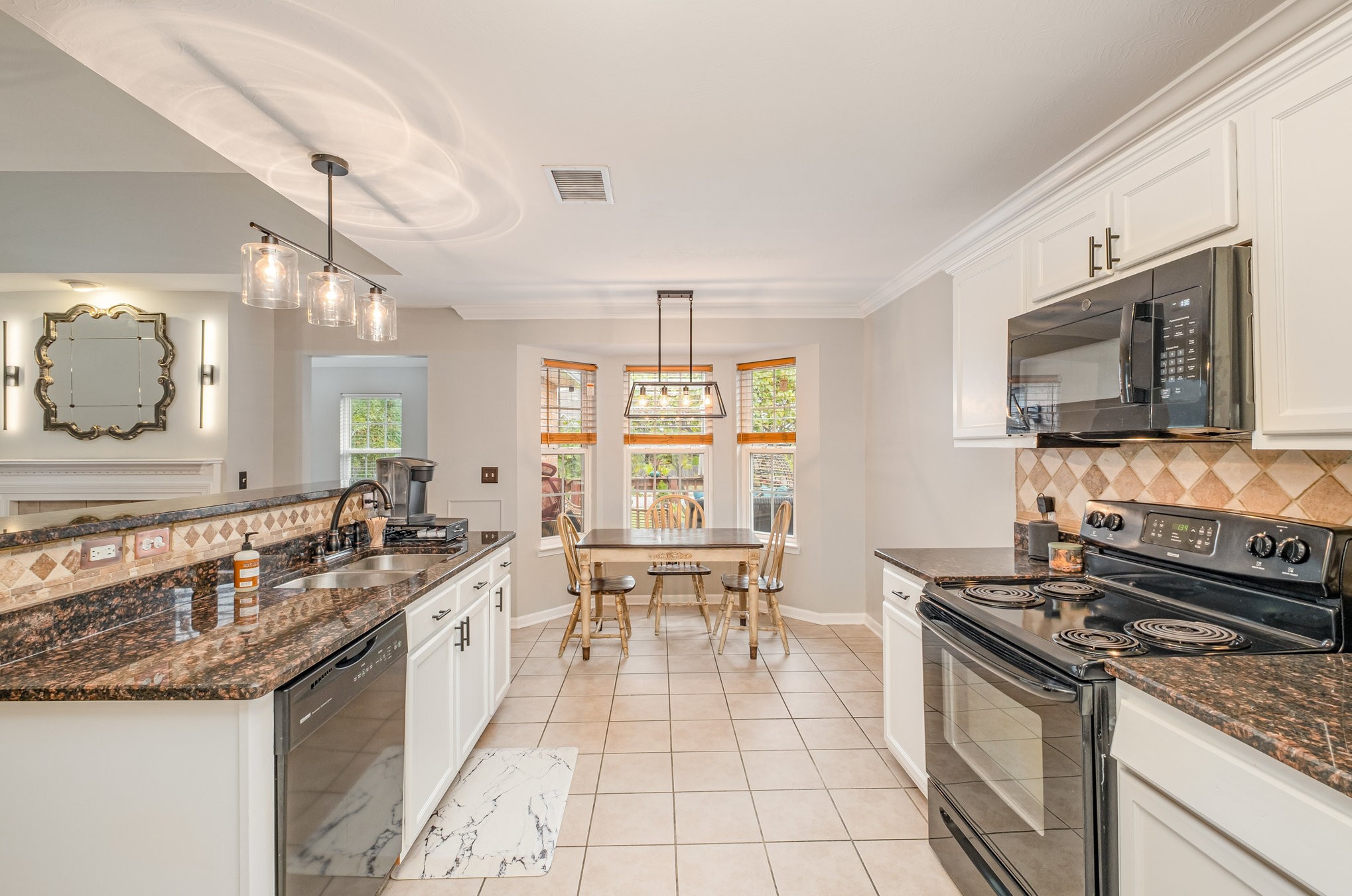 1312 Chapman Court Spring Hill, TN 37174 - Photo 9 of 27 a kitchen with stainless steel appliances granite countertop a sink stove and cabinets