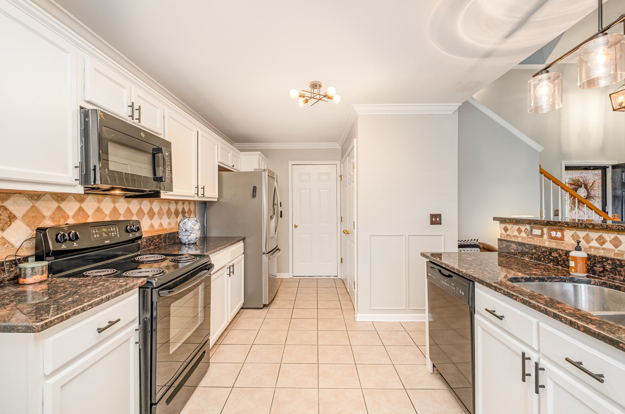 1312 Chapman Court Spring Hill, TN 37174 - Photo 10 of 27 a kitchen with stainless steel appliances a stove microwave and refrigerator