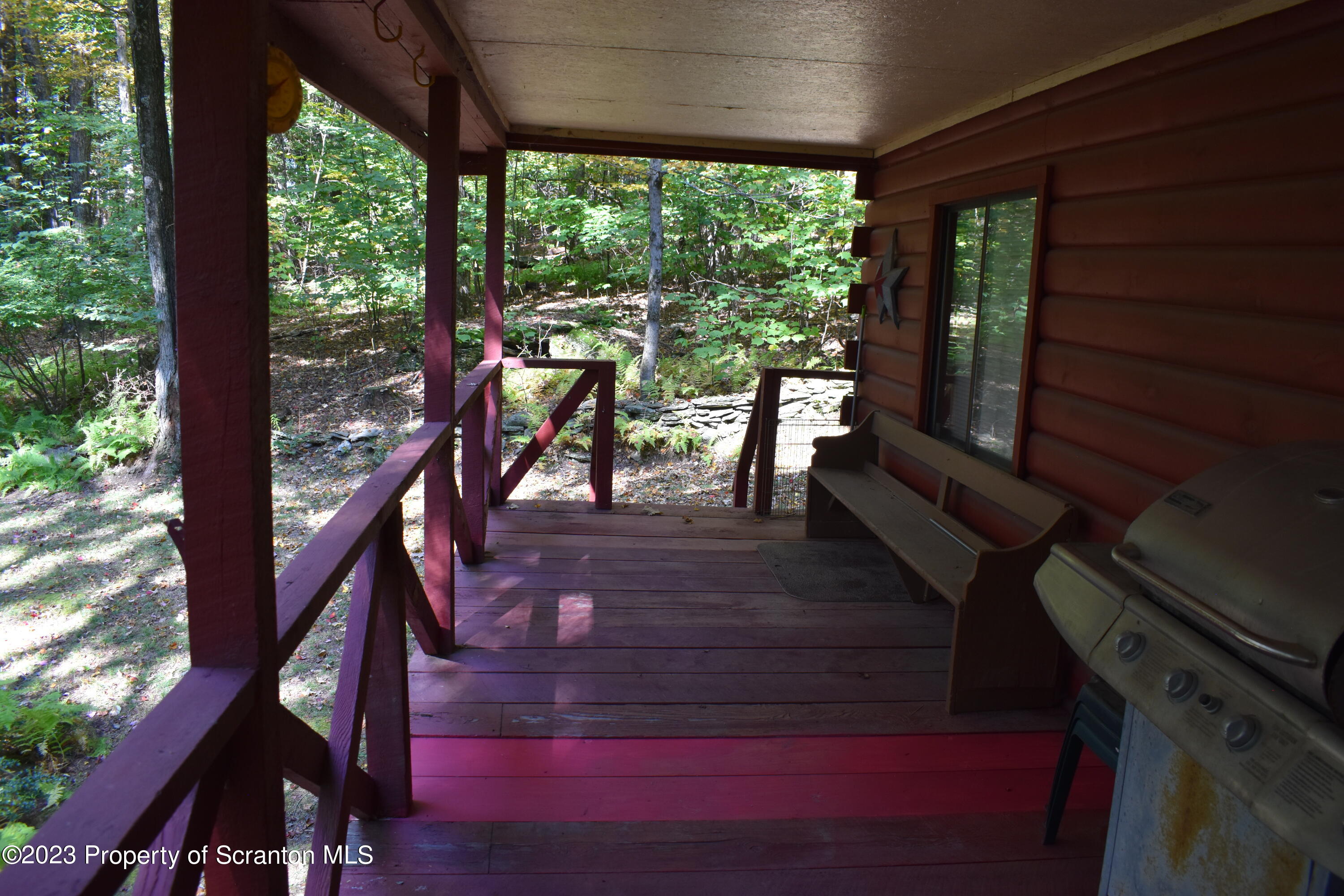 547 Camp Road New Milford, PA 18834 - Photo 18 of 27 a view of a porch with chairs and backyard