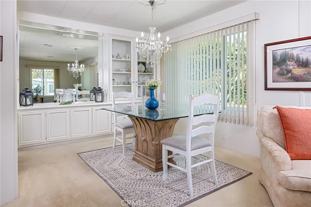 a dining room with wooden floor and large windows