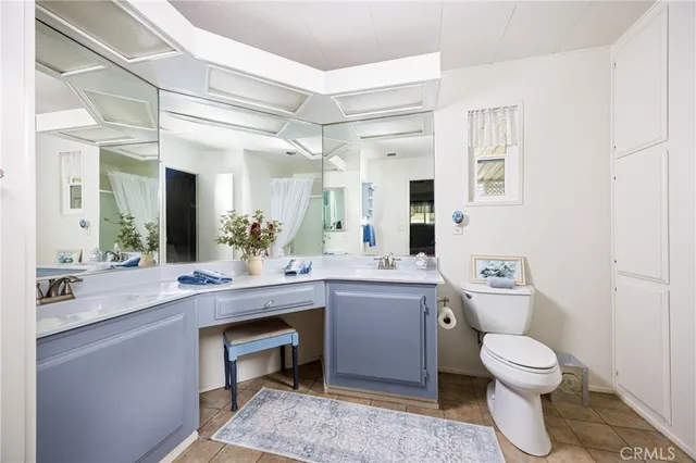 a spacious bathroom with a toilet sink and mirror