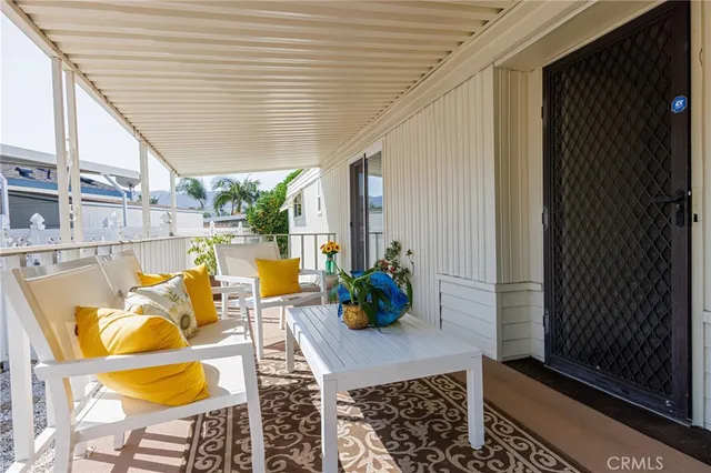 a view of balcony with dining table and chairs