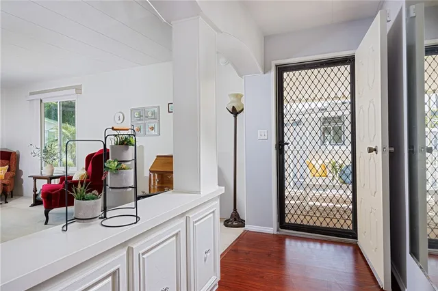 a view of a livingroom with furniture wooden floor windows and livingroom