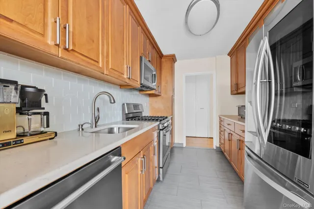 a kitchen with stainless steel appliances granite countertop a sink and cabinets