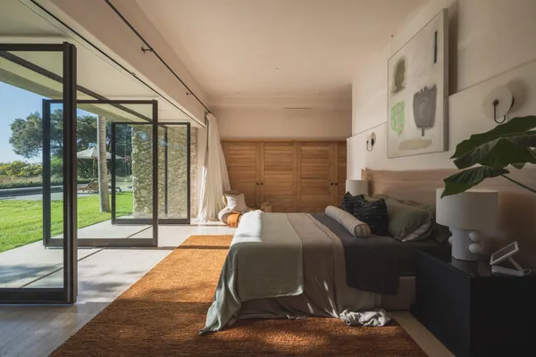 a spacious bedroom with a bed and a couch