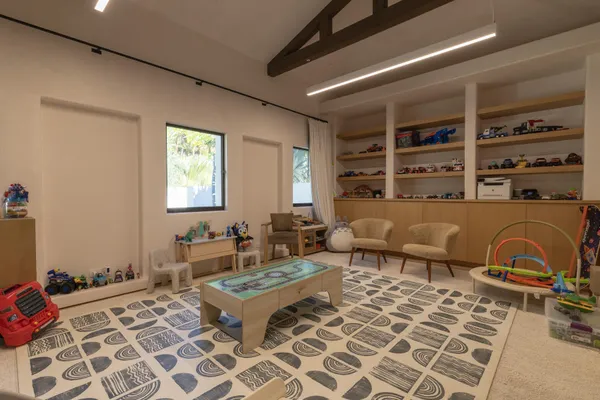 a living room with furniture and a floor to ceiling window