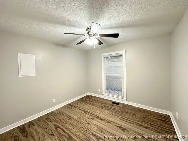 an empty room with fan and a ceiling fan