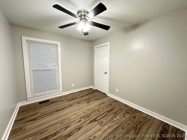 3305 Hunting Bay Drive Spring Lake, NC 28390 - Photo 13 of 15 an empty room with wooden floor and a ceiling fan