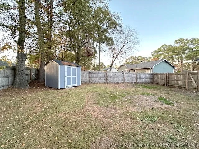 a backyard of house with a stove and tree