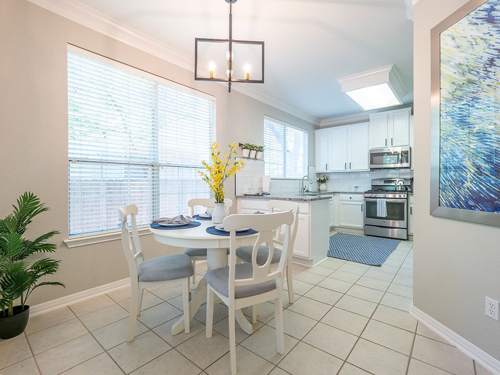 8518 Cahill Drive, Unit 47 Austin, TX 78729 - Photo 12 of 28 a kitchen with stainless steel appliances a table and chairs in it