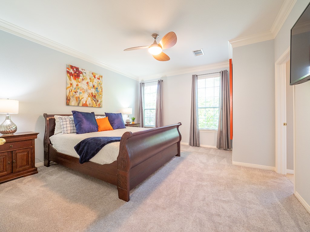 8518 Cahill Drive, Unit 47 Austin, TX 78729 - Photo 17 of 28 a spacious bedroom with a bed and a chandelier