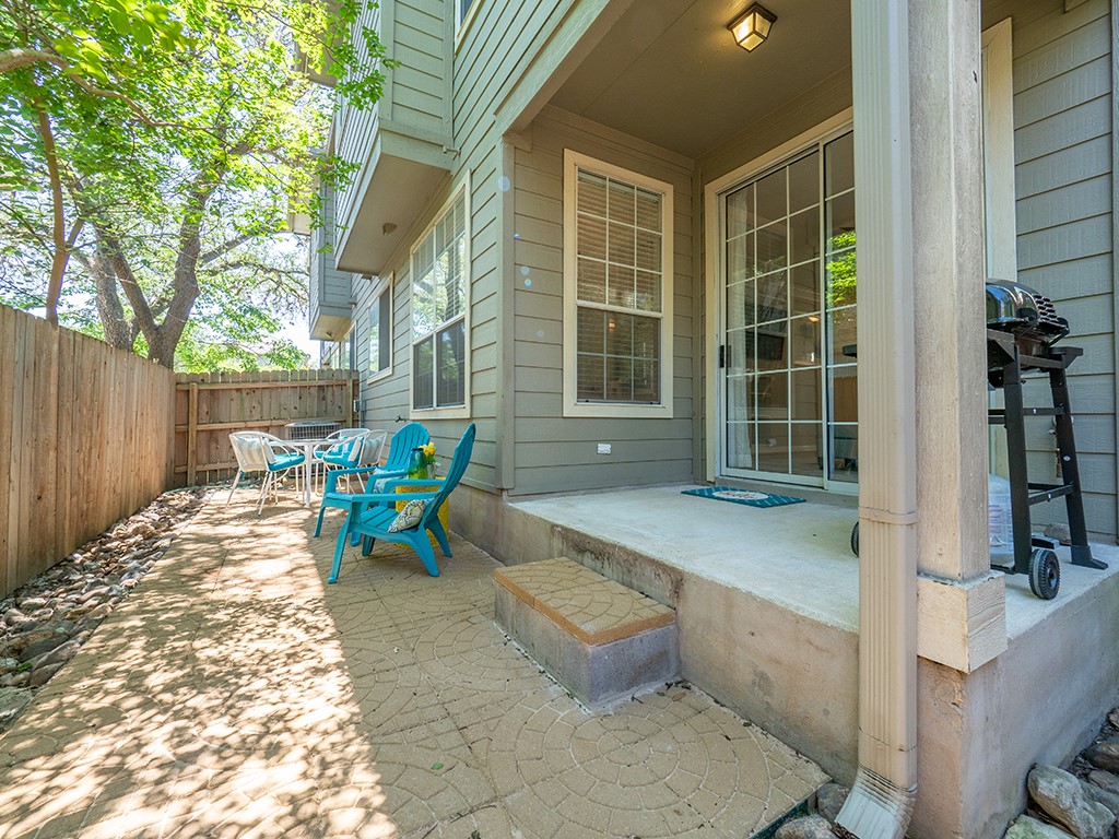8518 Cahill Drive, Unit 47 Austin, TX 78729 - Photo 4 of 28 a building outdoor space with patio furniture and potted plants